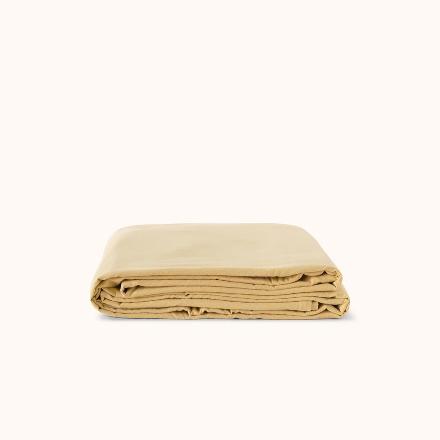 Folded yellow flat sheet on a white background
