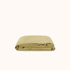 Folded green flat sheet on a white background