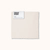 An organic matte sateen Oat fabric swatch with a Morrow label